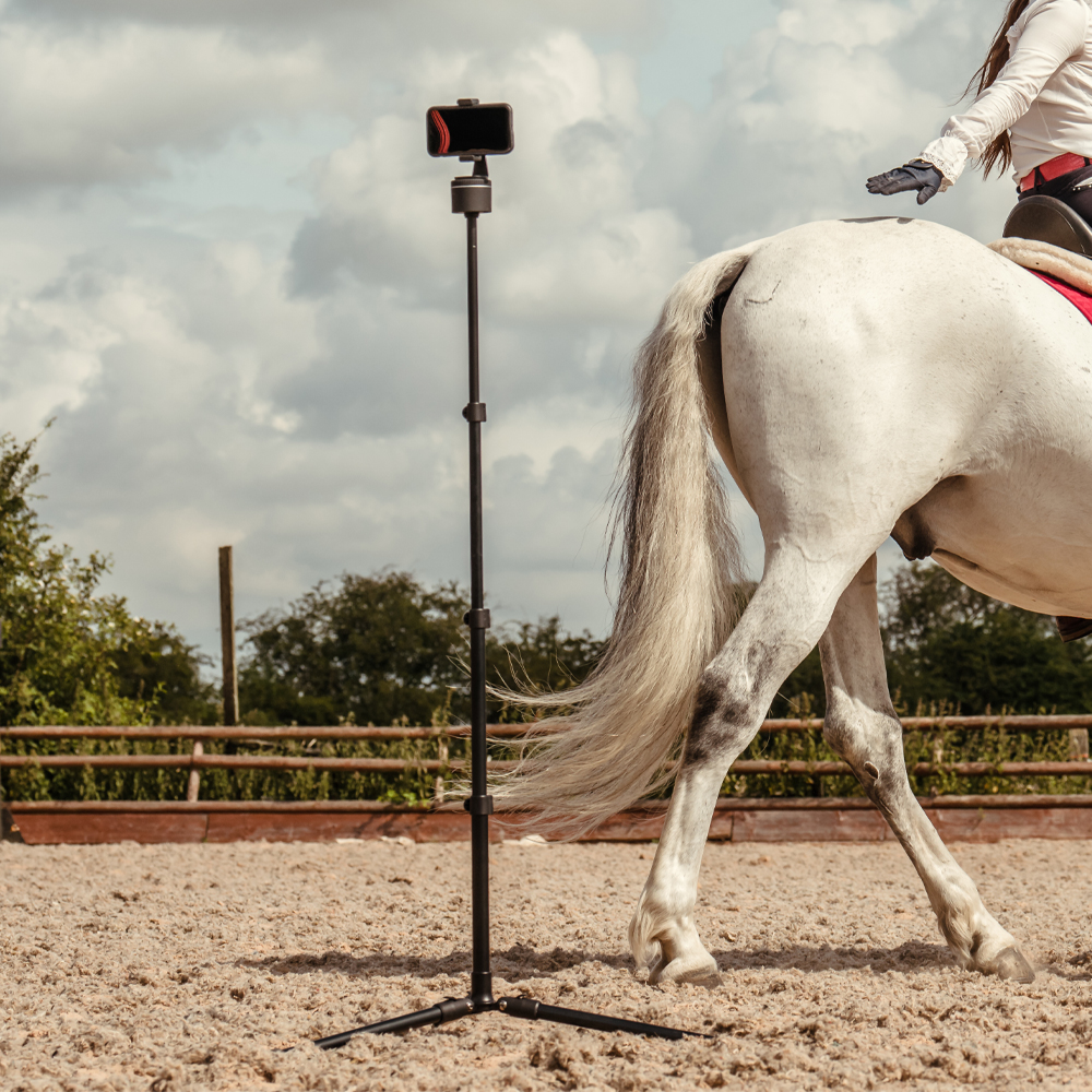 Pivo Tripod capturing equestrian moments, adjustable and lightweight for versatile videography.